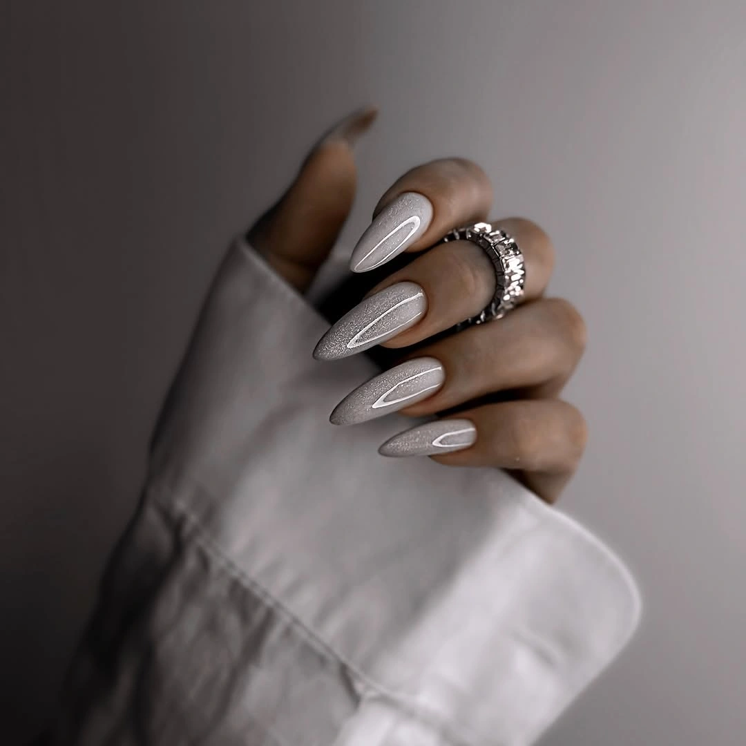 Pearly almond nails with delicate inner white outlines