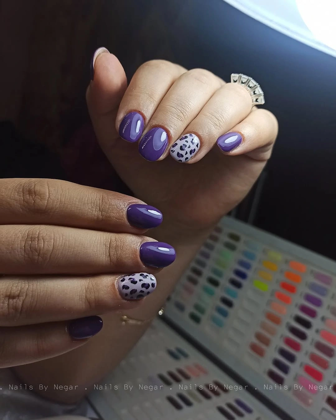 Medium almond purple nails with one pale spotted accent