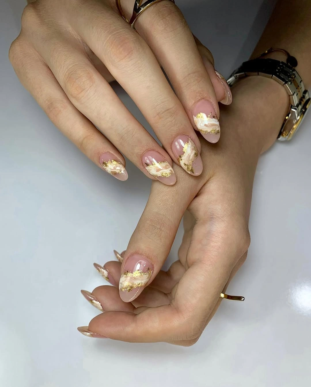 Long pale almond nails with delicate floral and warm accents