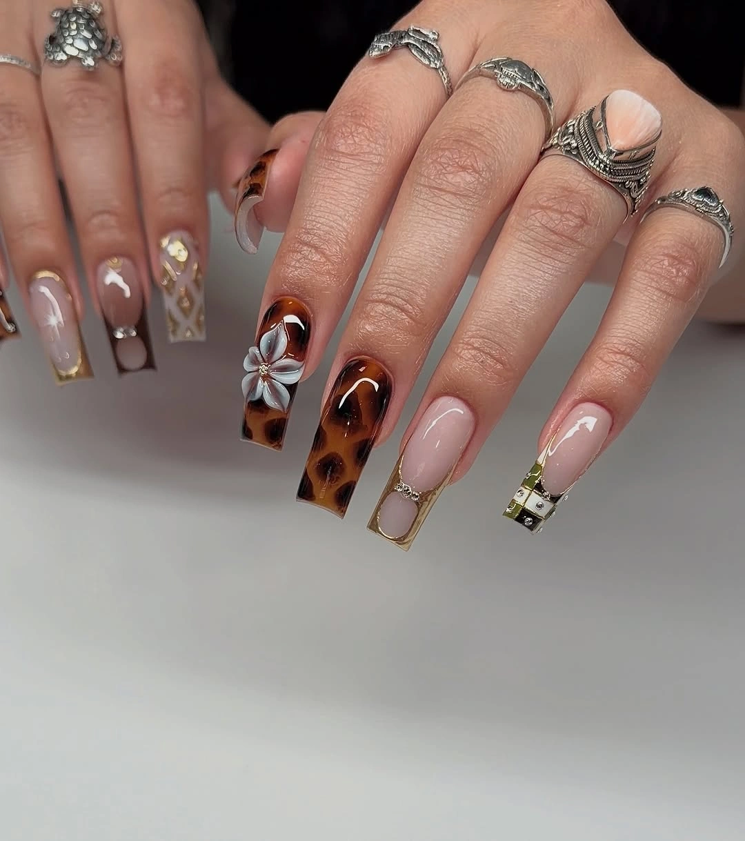 Long almond pale nails with amber tortoiseshell and fine warm lines
