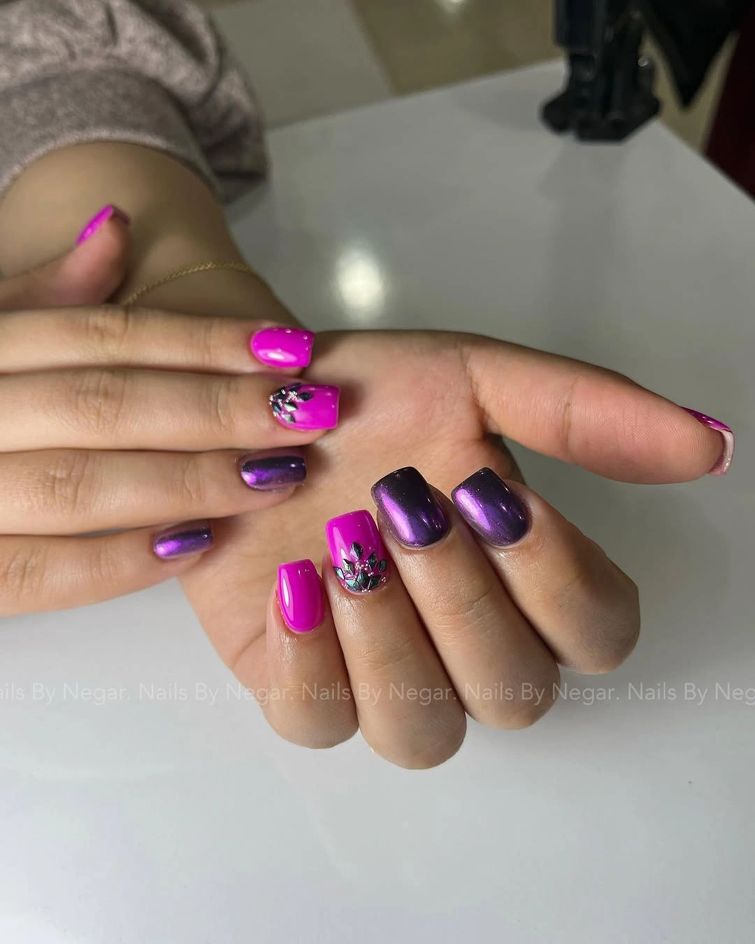 Long square fuchsia and purple nails with small reflective accents