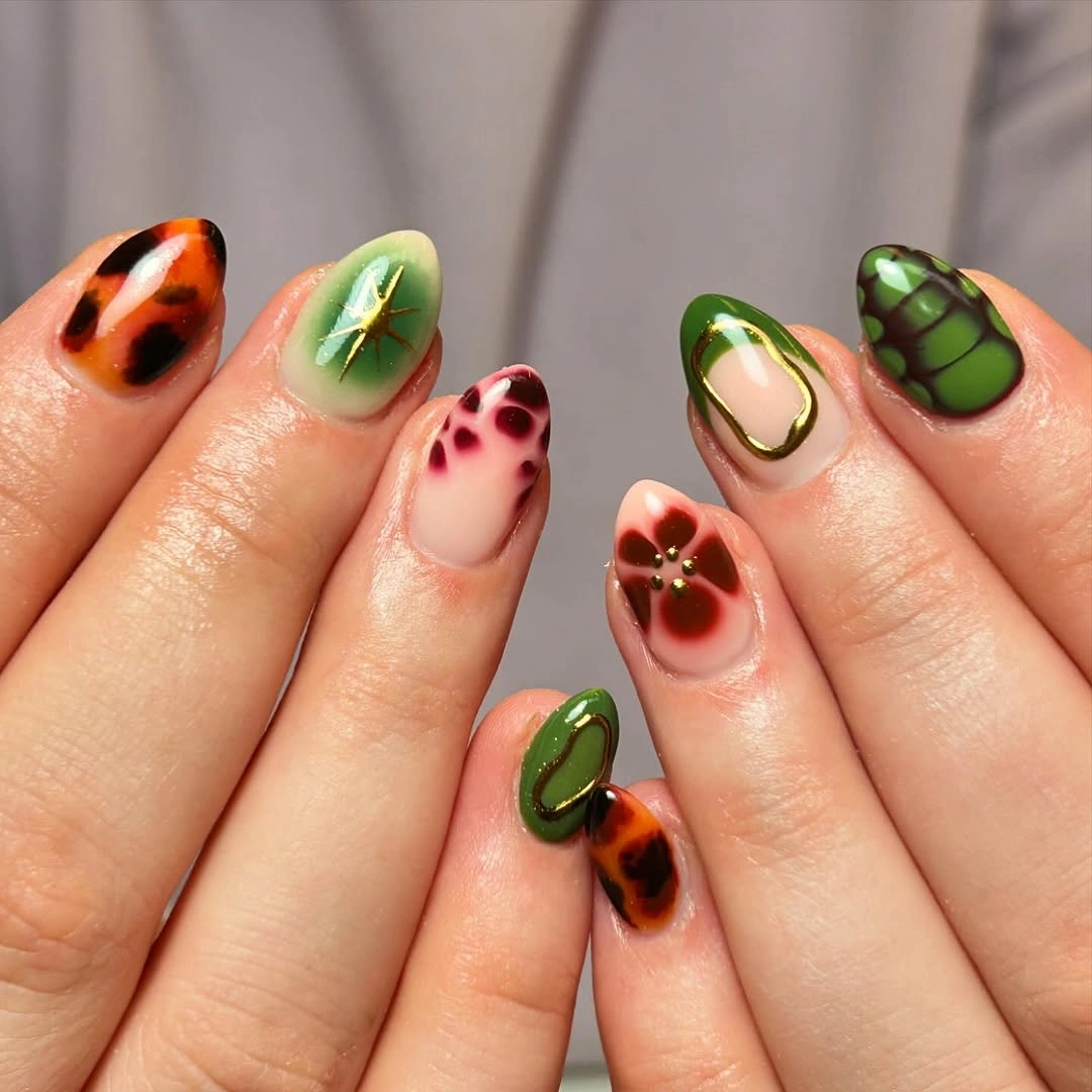Short almond nails with orange green red and brown autumn motifs