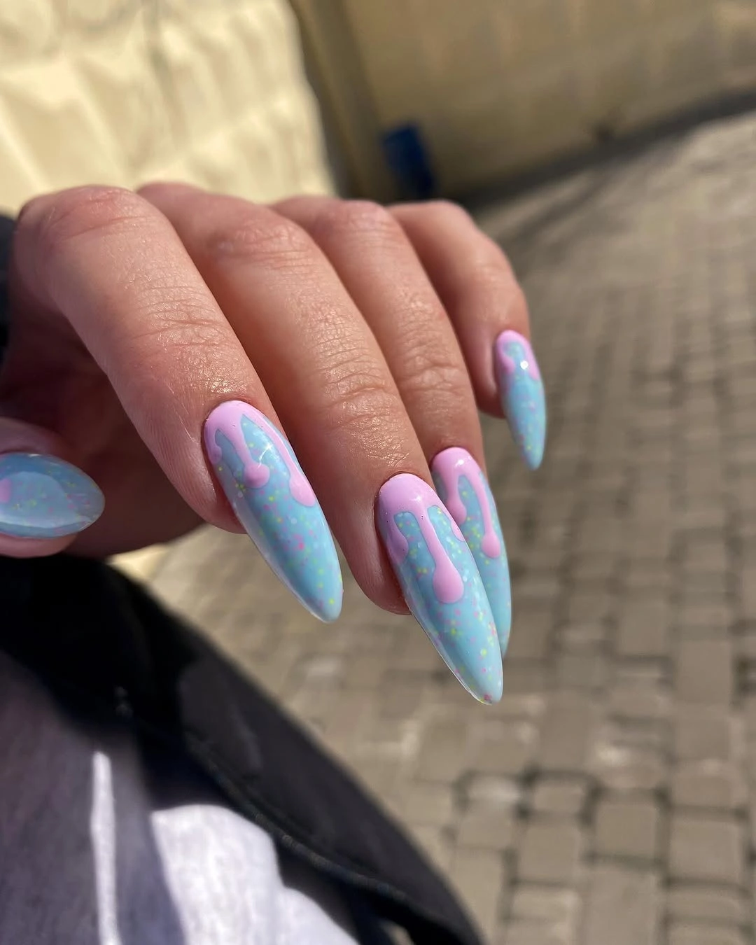 Pastel blue almond nails with pink drip accents