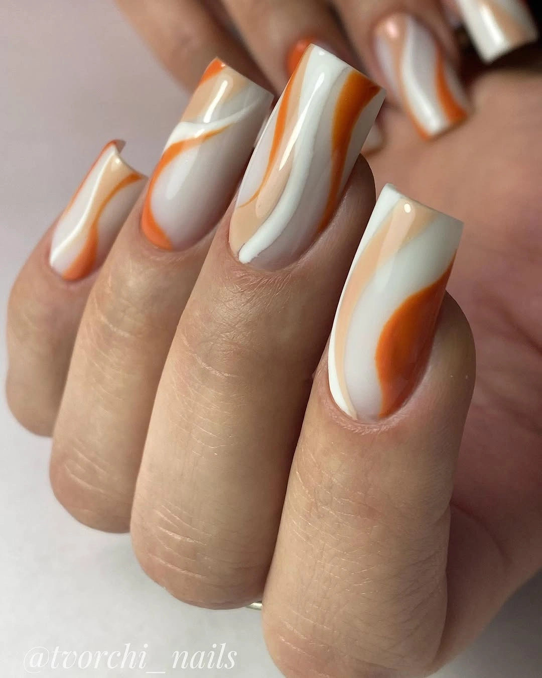 Creamy square fall nails with caramel orange swirls