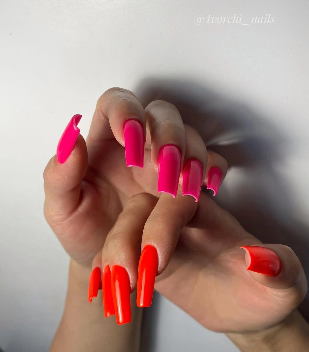 Hot pink and orange square nails split by hand