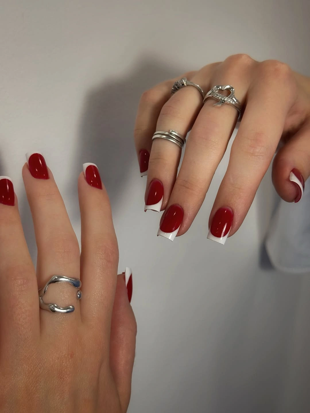 Glossy red square nails with white swoop tips
