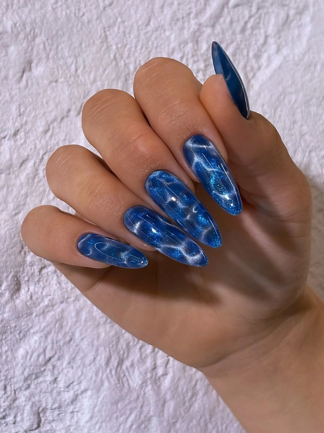 Deep blue almond fall nails with cloudy shimmer