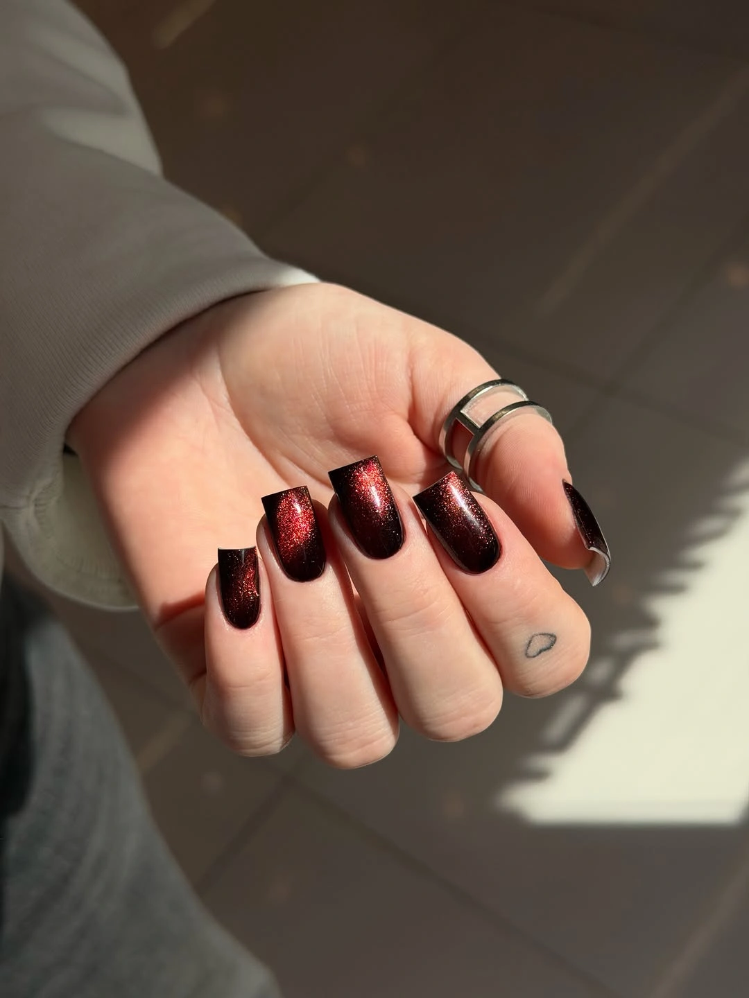 Blackened burgundy square nails with red sparkle