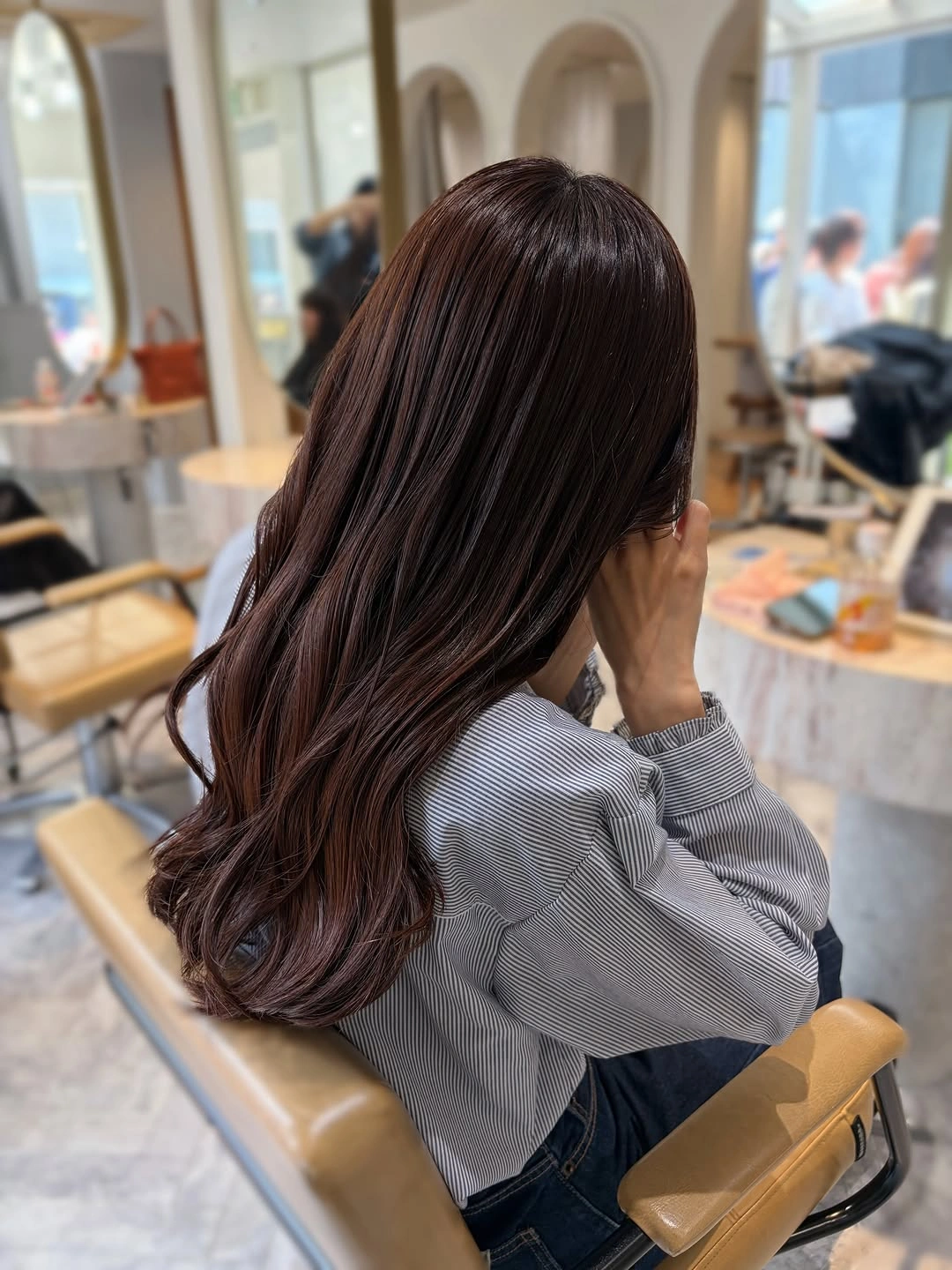 Long chestnut brown waves with subtle lighter ribbons
