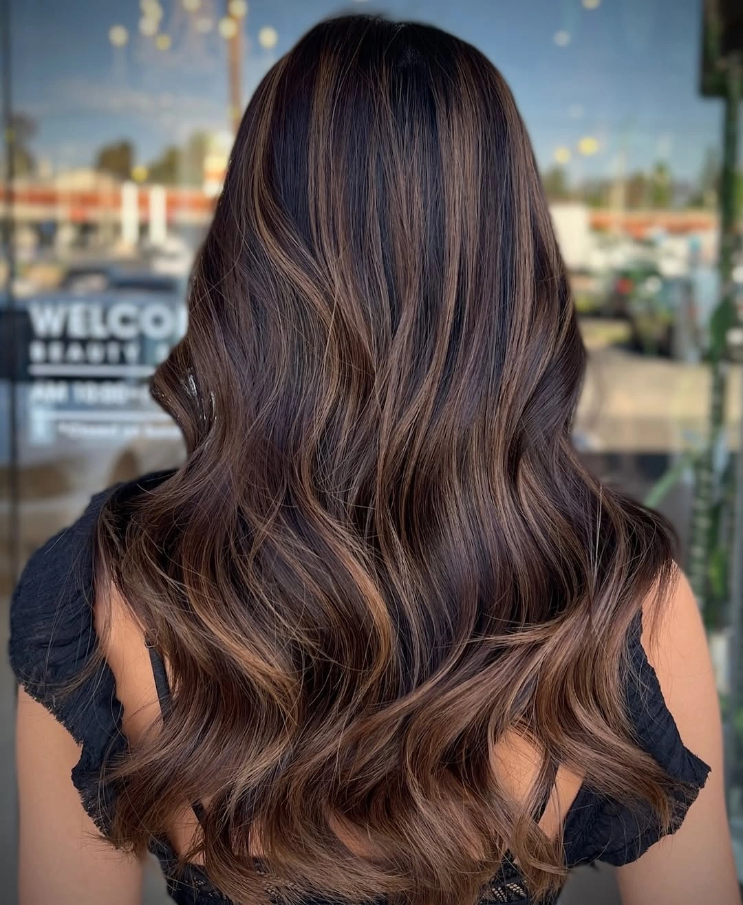 Long brown waves with warm caramel outer ribbons and lighter ends