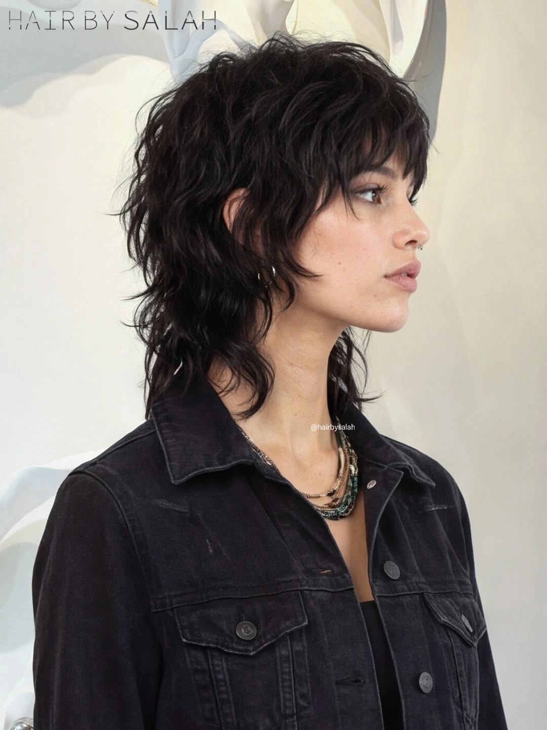 Short dark brown textured shag with piecey layers and feathered fringe
