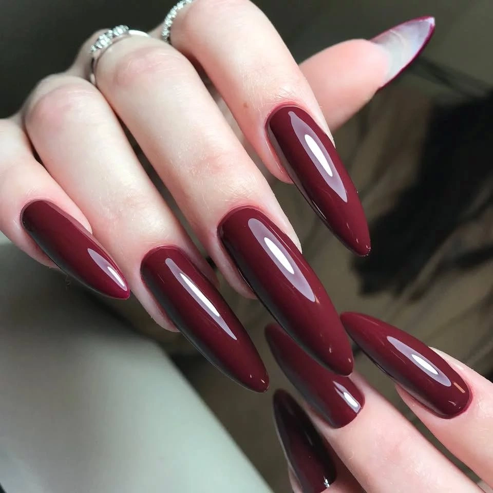 Long almond burgundy nails with subtle tonal depth
