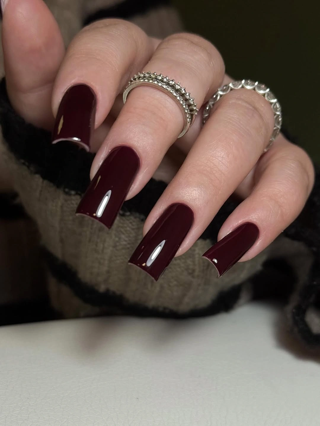 Long square burgundy nails with one pale pink accent