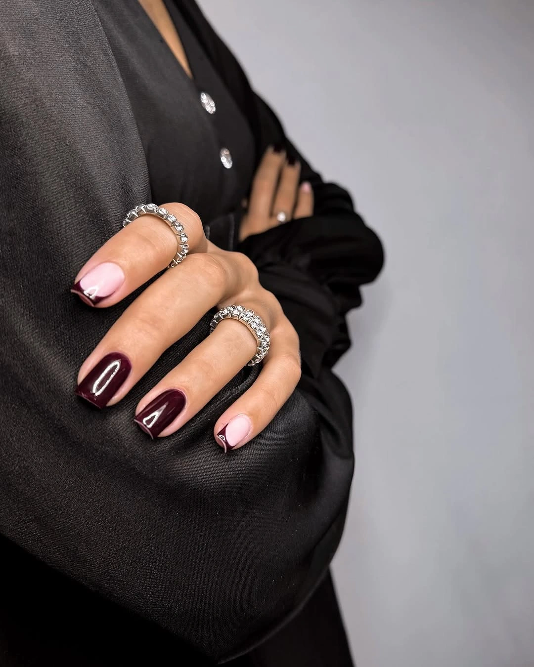 Long burgundy square nails with a pale symbol accent