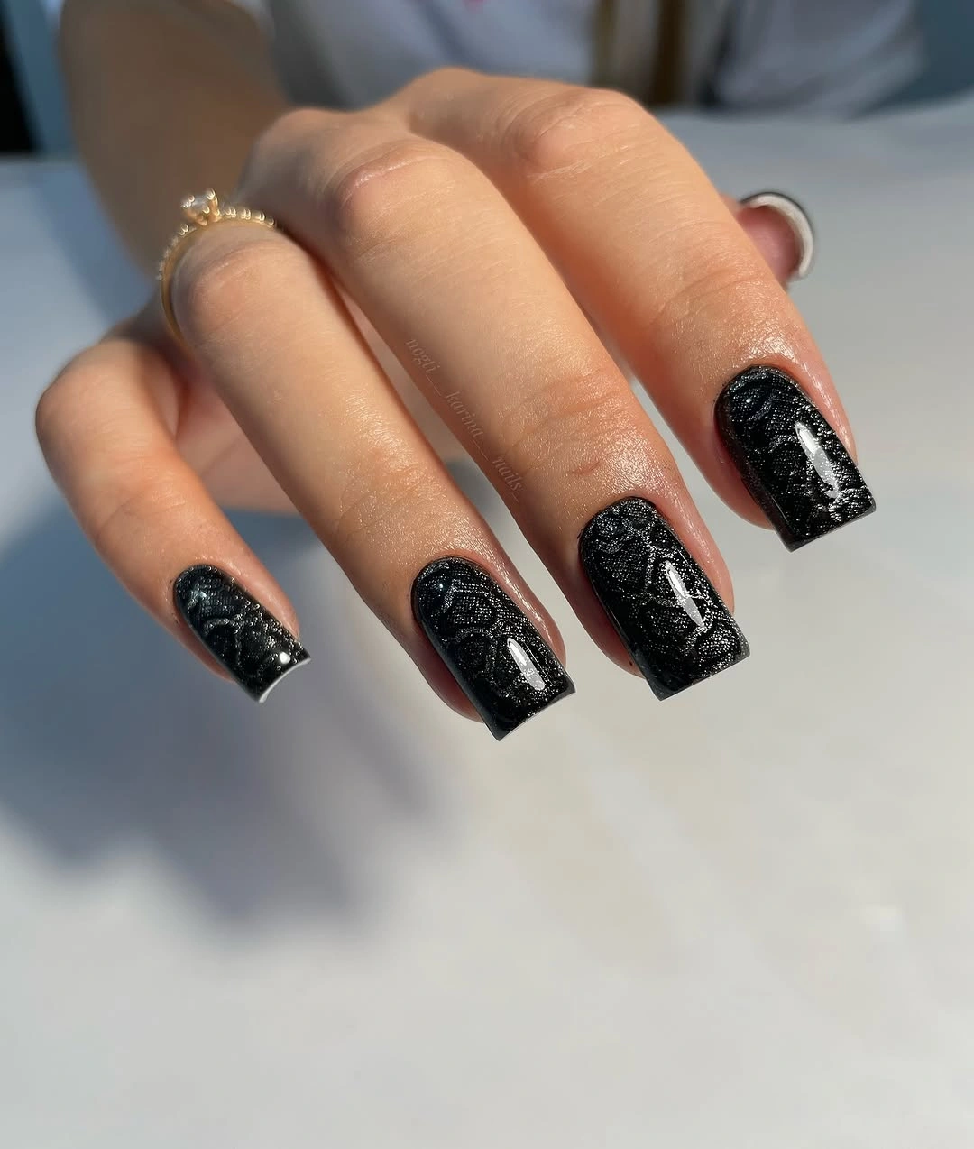 Medium square black nails covered with fine silver speckled texture