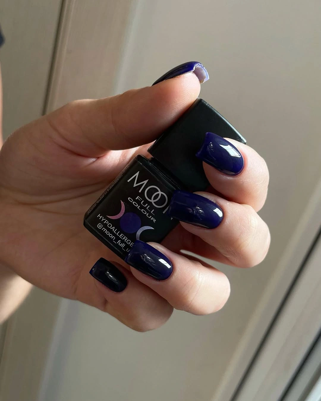 Cobalt blue almond nails balanced by a darker black accent nail