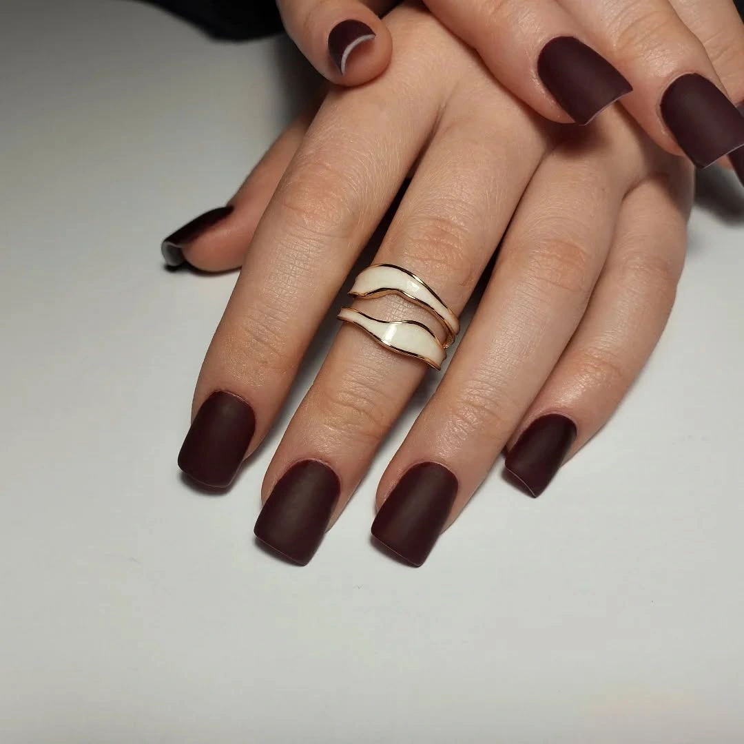 Medium square matte burgundy nails with a soft low-shine finish