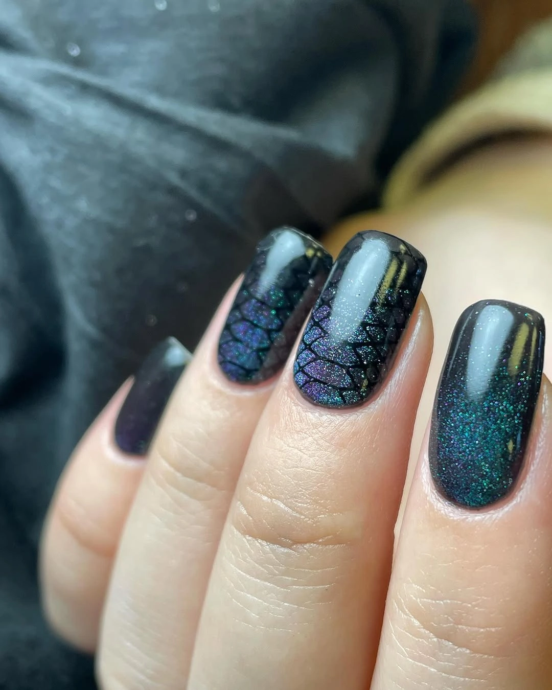 Dark teal textured nails with a few plain dark accent nails