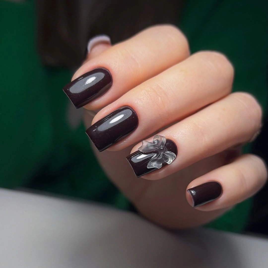 Dark brown square nails with one small silver reflective accent