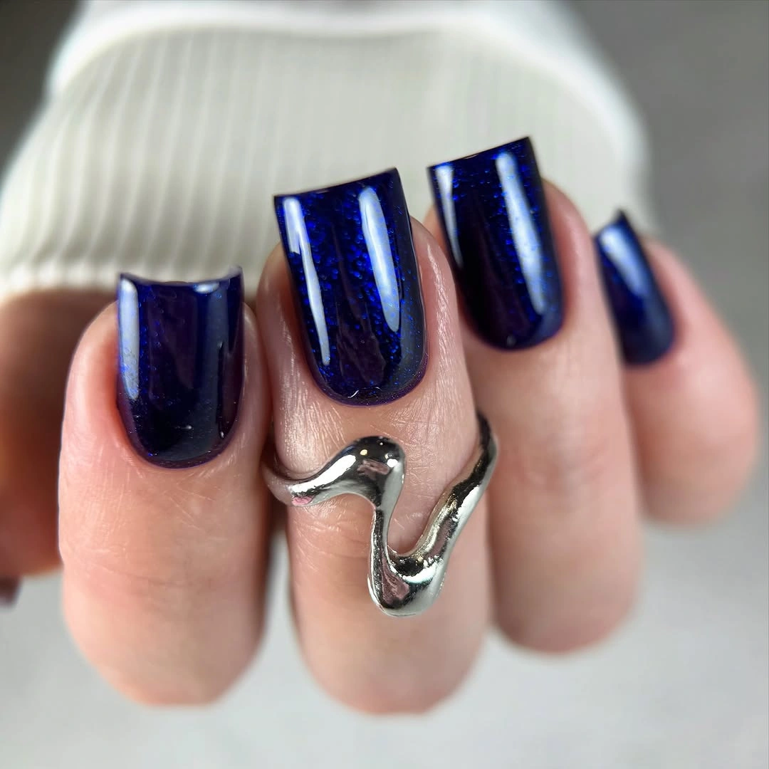 Long glossy deep navy square nails with cool reflective depth