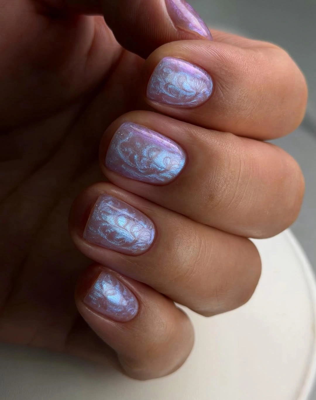Short pearly lavender blue nails with soft swirls