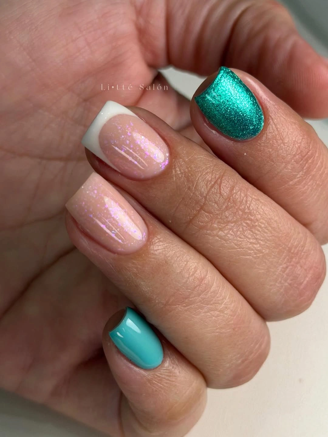 Short pink oval nails with teal turquoise and silver accents