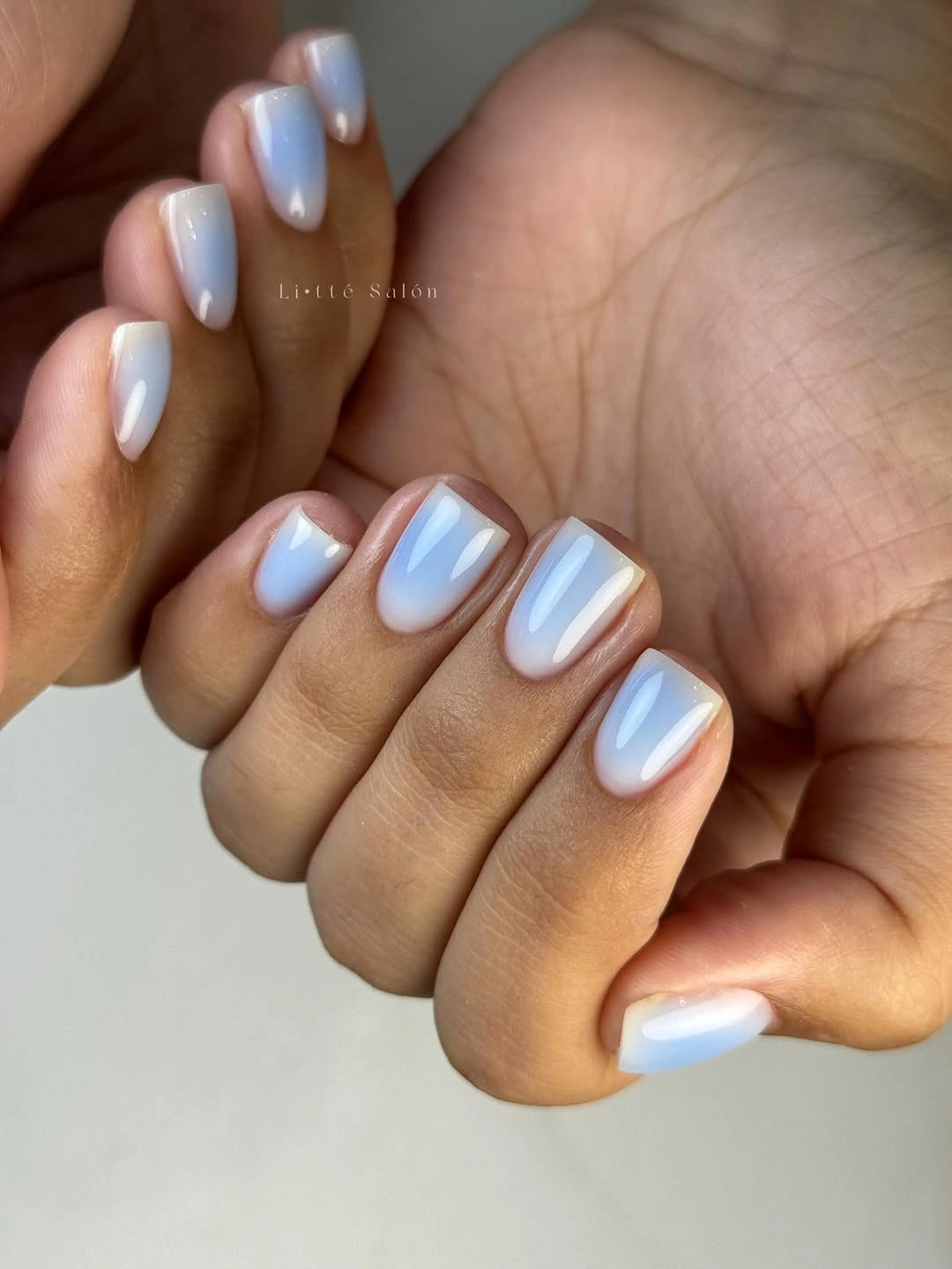 Short square milky white nails with lavender blue shading