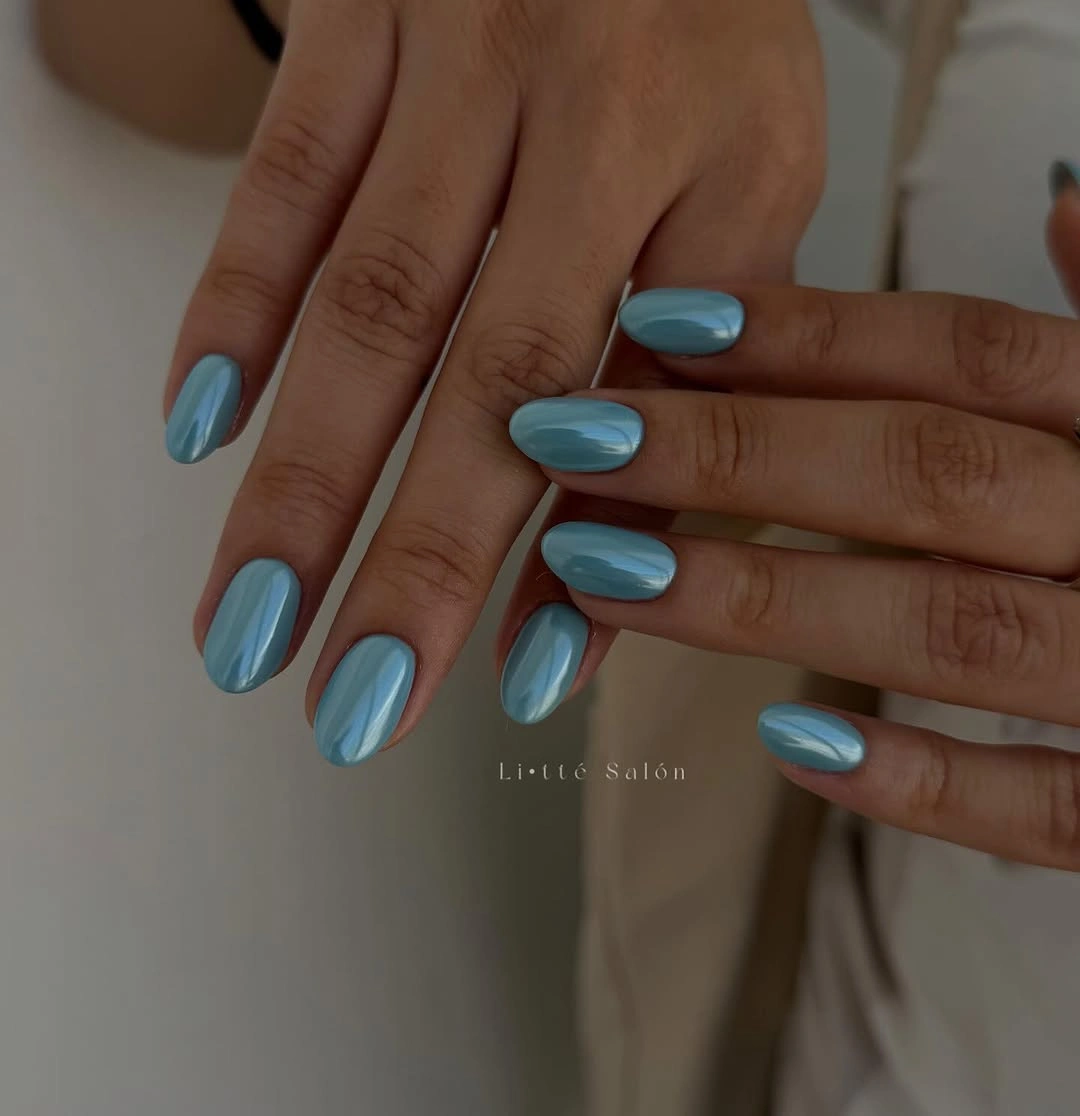 Medium almond nails in deep glossy teal blue