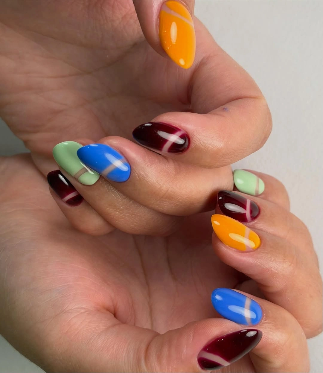 Bright orange blue mint and burgundy curved band nails