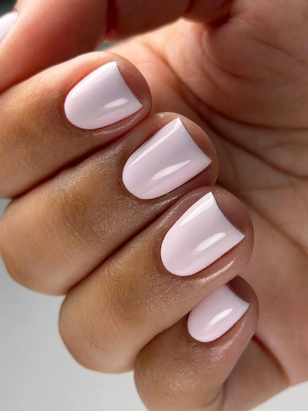 Short glossy milky blush squoval nails
