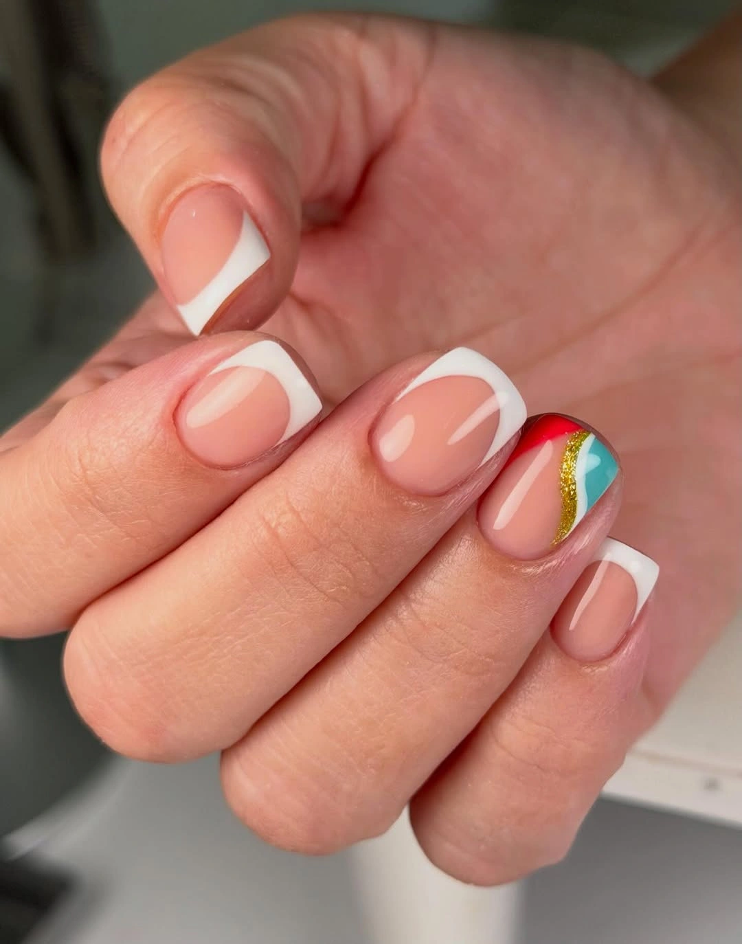 Sheer nude square nails with white tips and colorful accent