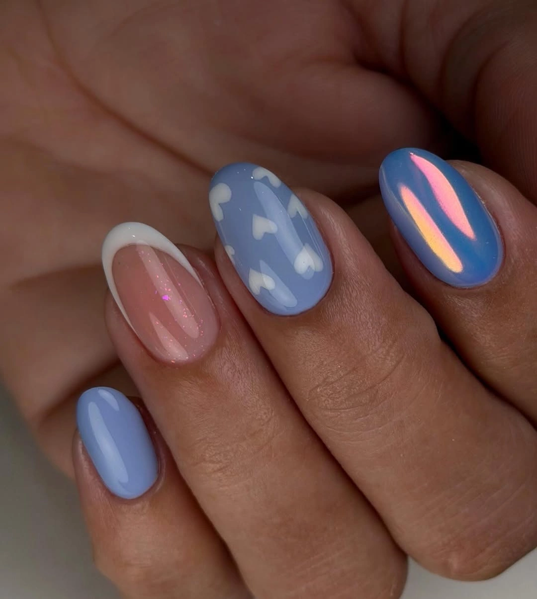 Pastel blue and pink almond nails with cloud accents