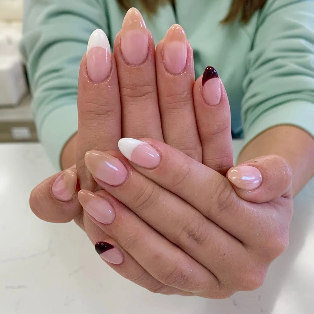 Medium almond nails with a translucent pink base and burgundy micro tips