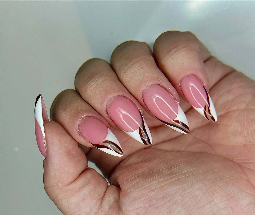 Long stiletto nails with layered black white and burgundy V tips