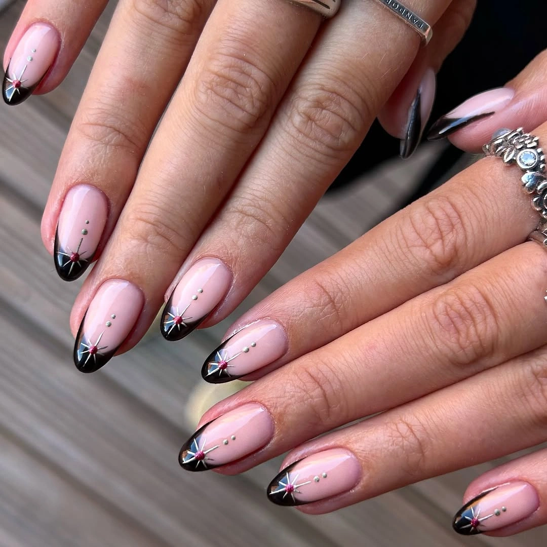 Long almond nails with black tips white outlines and small dark dots