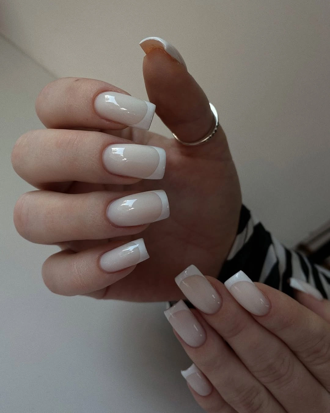 Medium square nails with a milky base and crisp white French edges