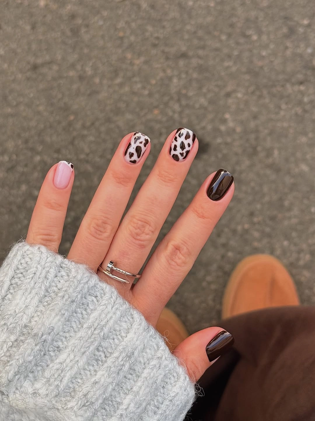 Short square nails with pale pink and dark spotted accents