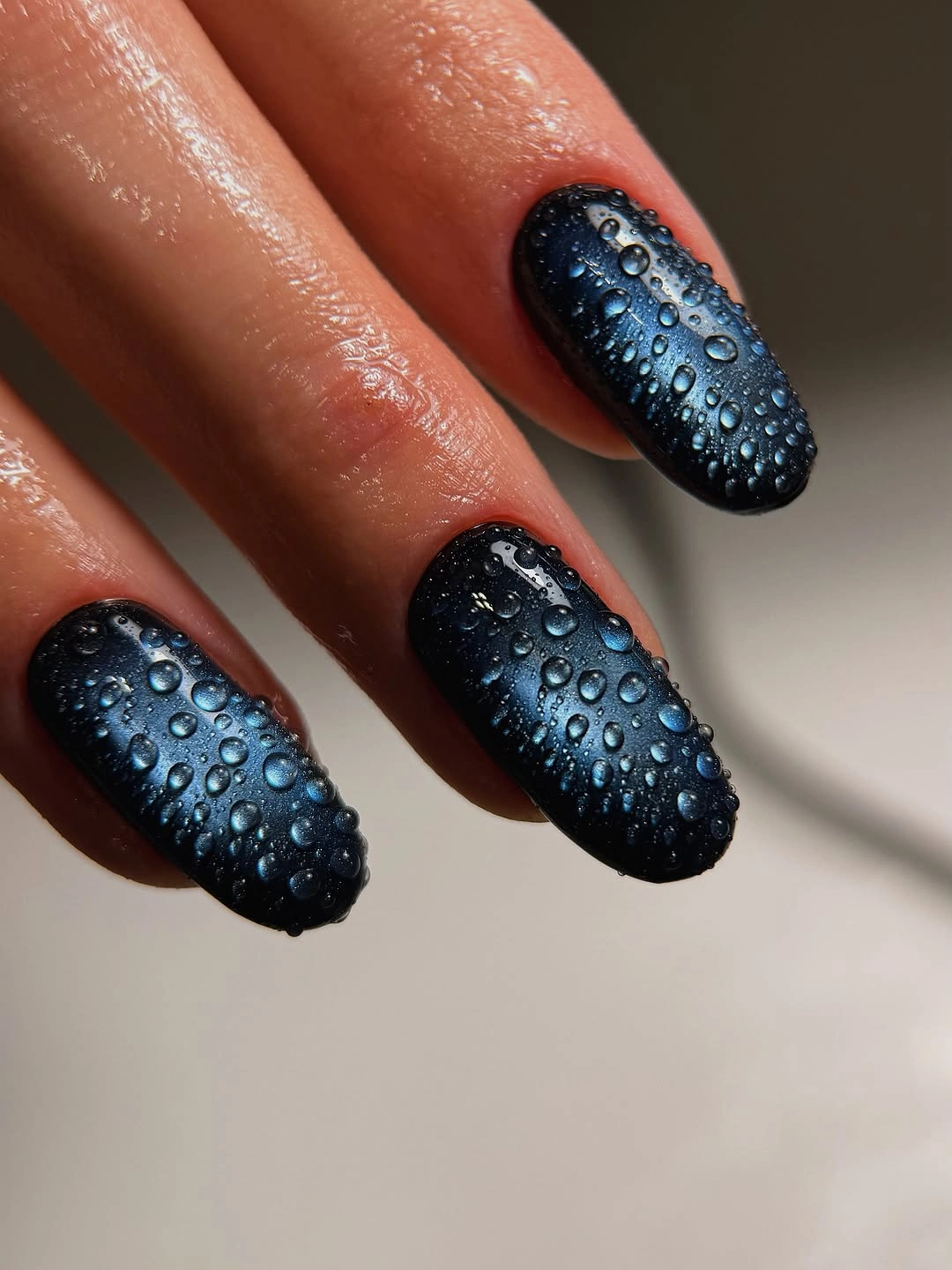 Medium square dark blue nails with rounded droplet texture