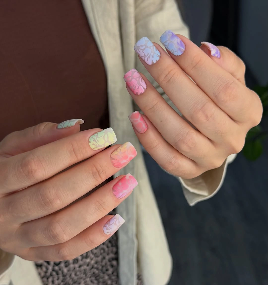 Short square nails with pastel pink lavender mint and yellow shapes