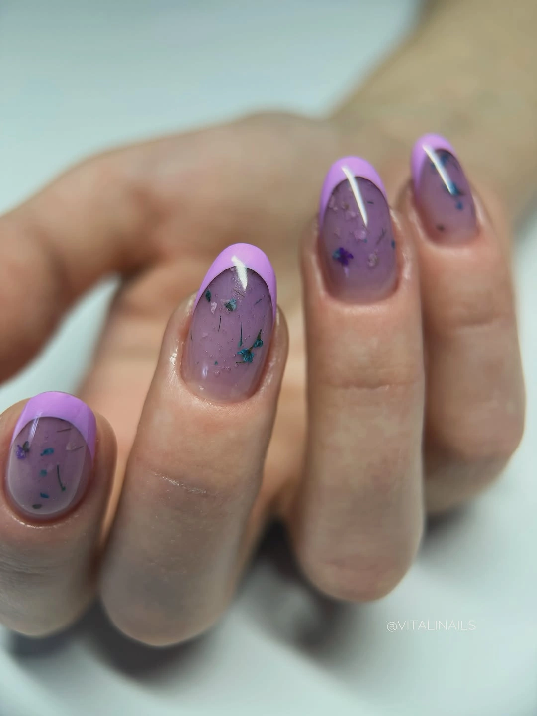 Short lavender nails with lilac tips and tiny colored fragments