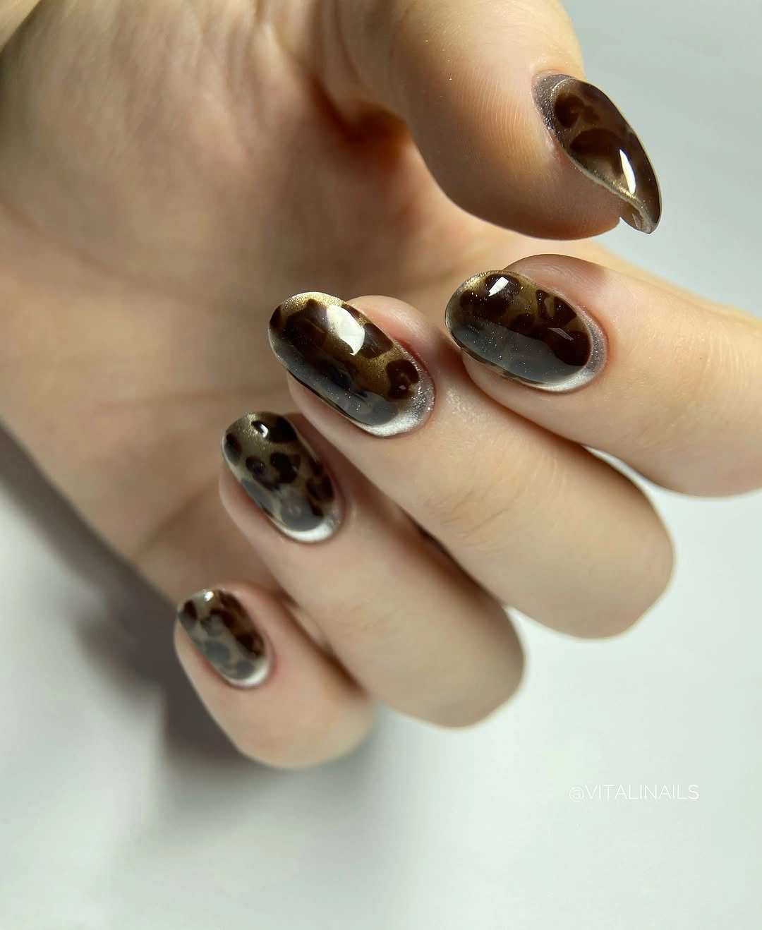 Medium oval nails with brown abstract patches and soft edges