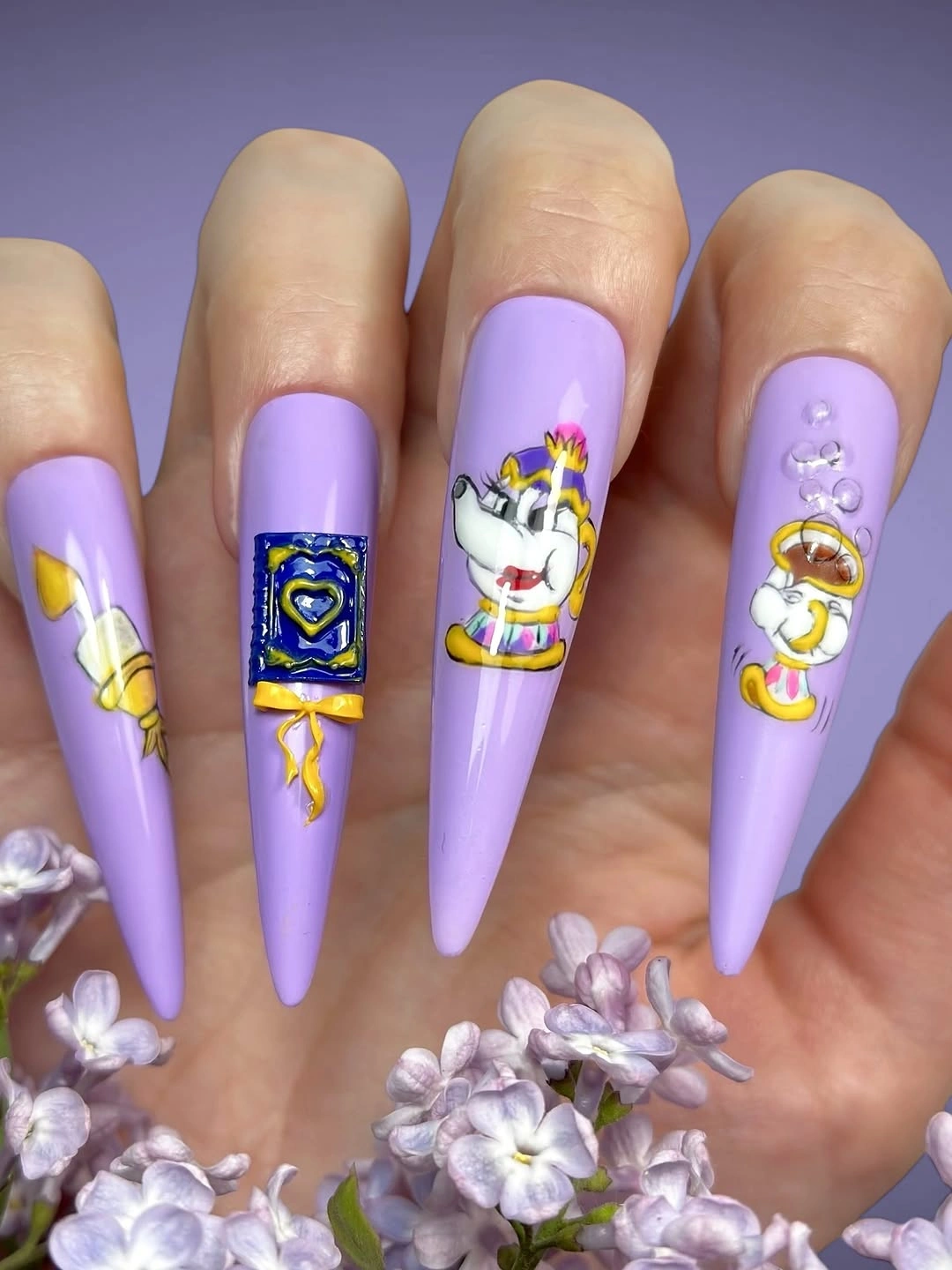 Lavender stiletto nails with colorful illustrated character accents