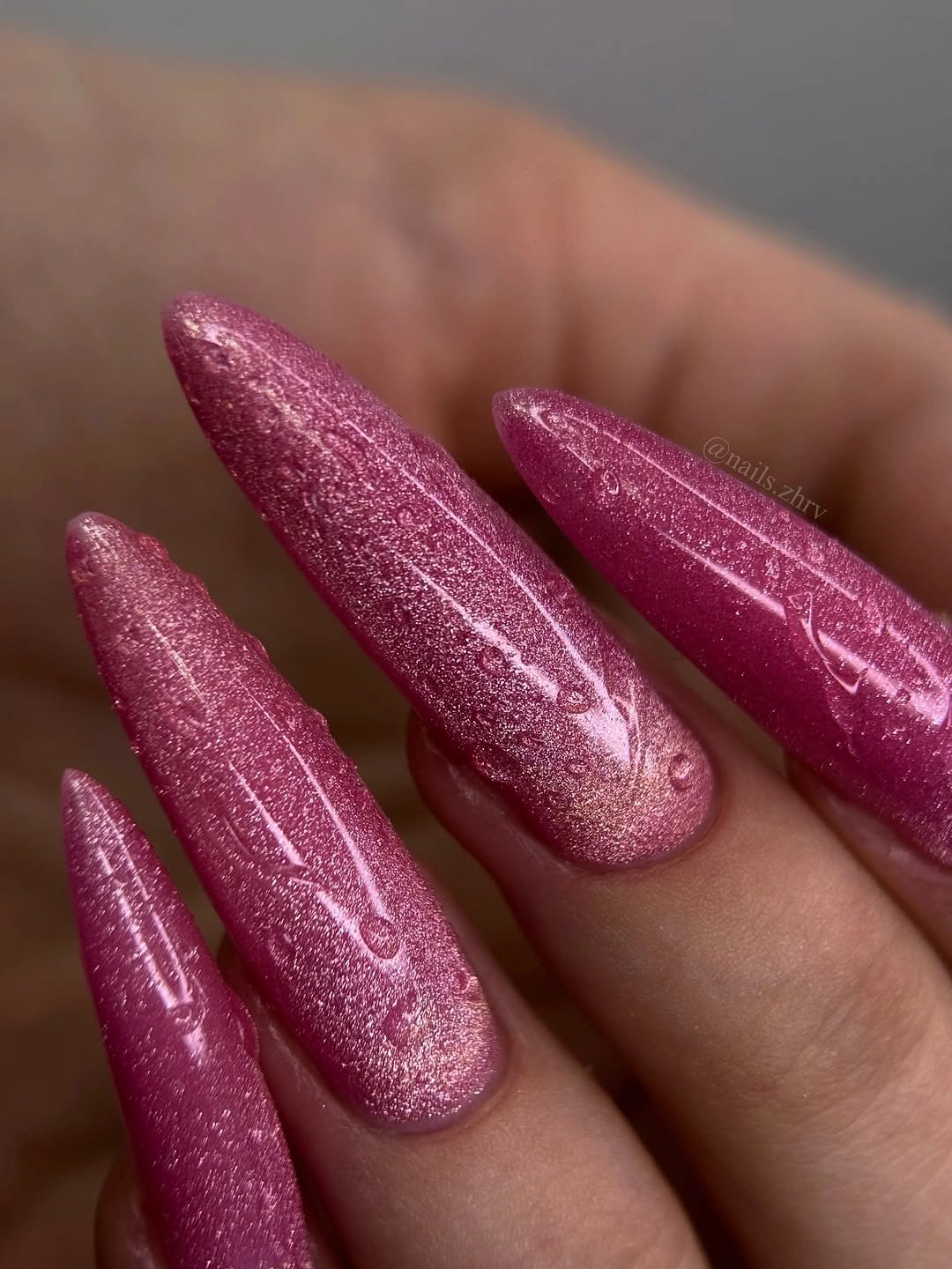 Long rose pink almond nails with fine reflective shimmer