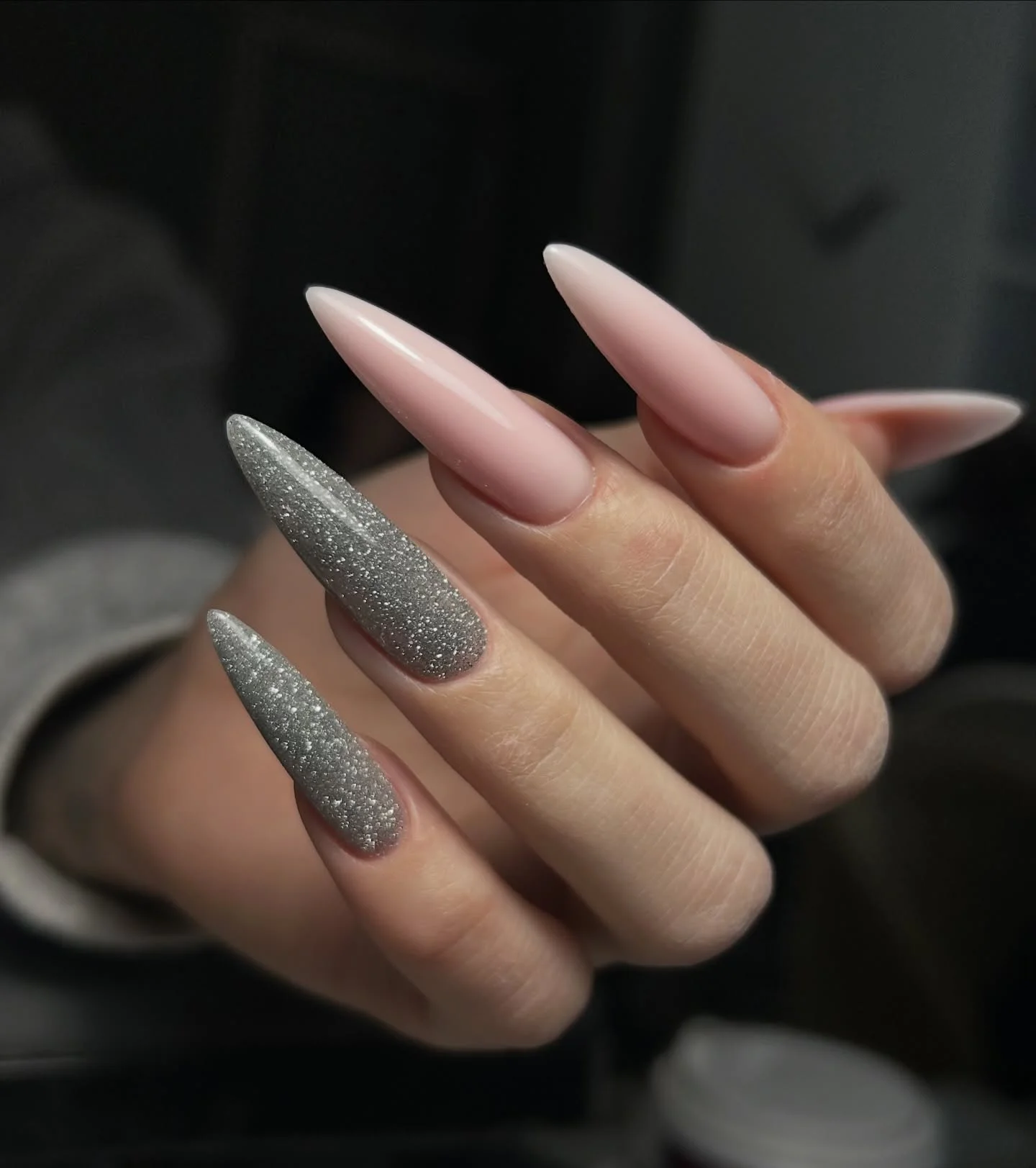 Long blush almond nails with a single silver glitter accent