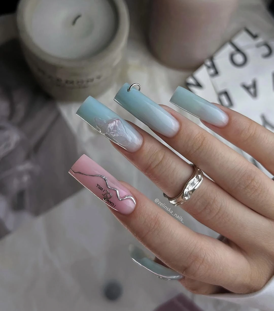 Long coffin nails blending icy blue white and pale pink