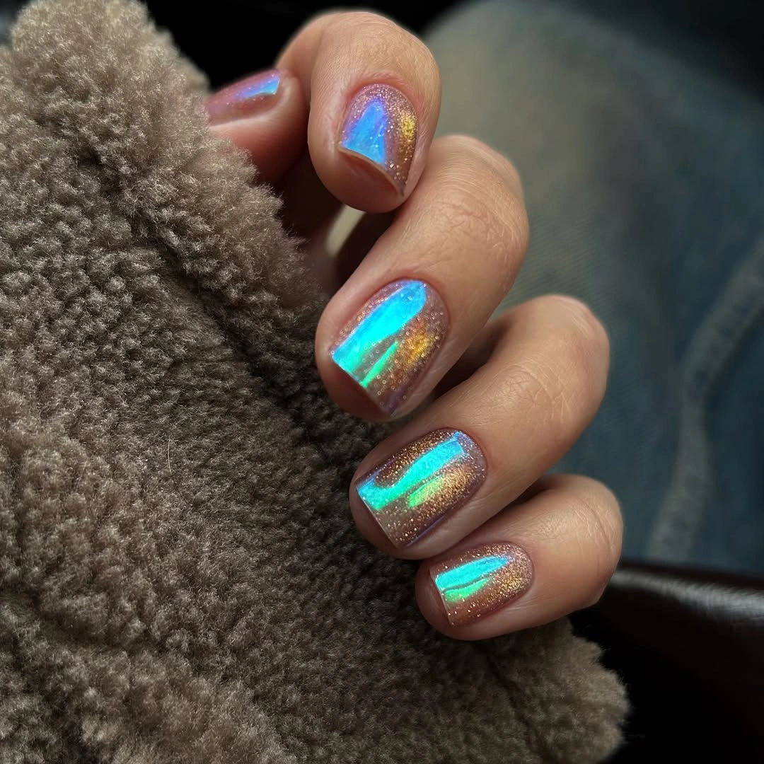 Medium oval nails with turquoise gold and purple reflective shifts