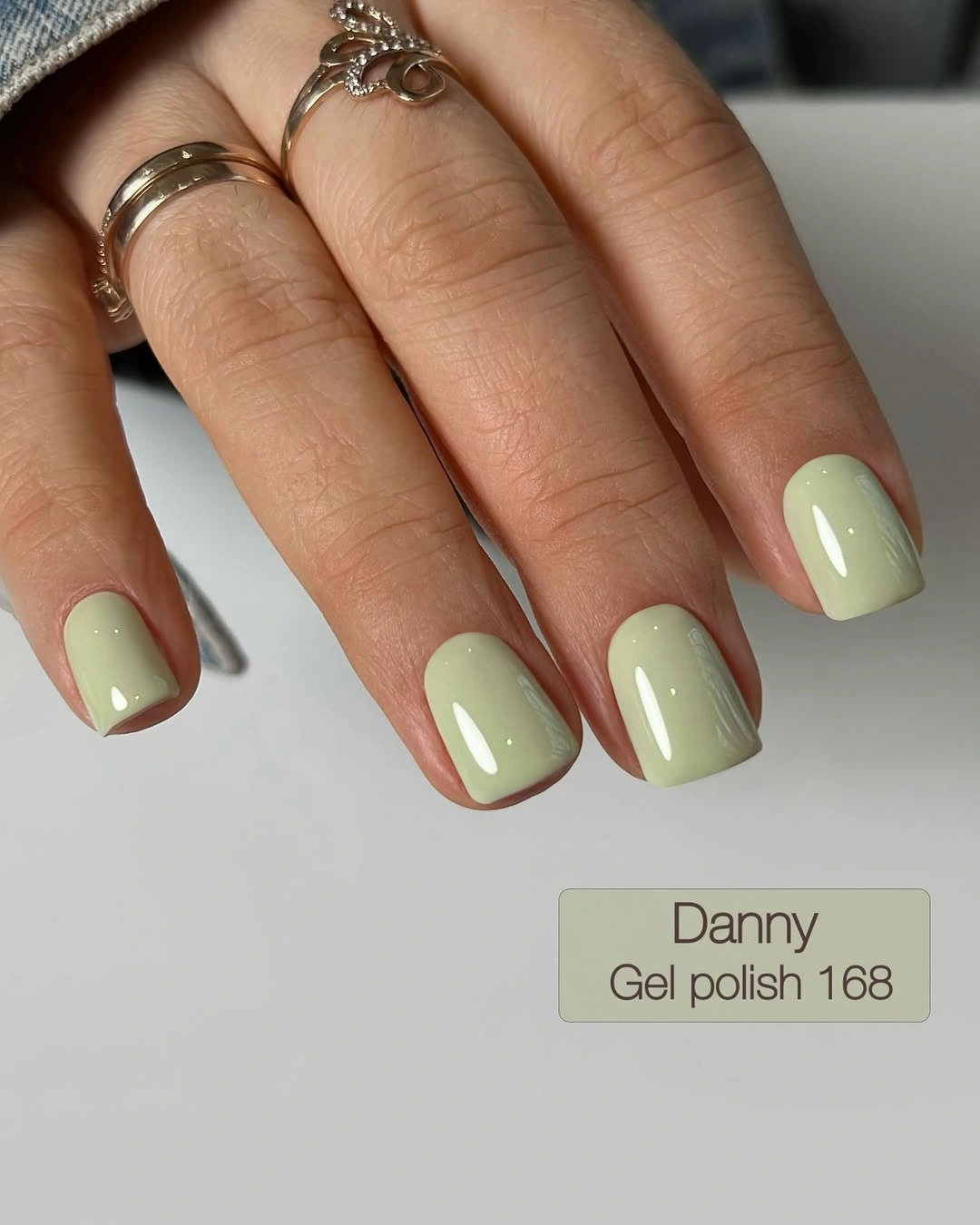 Short square nails in glossy pale sage green