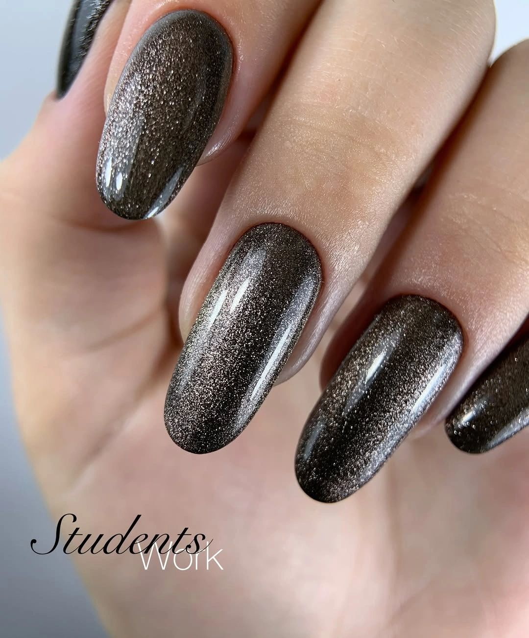 Medium rounded nails in reflective charcoal gray shimmer