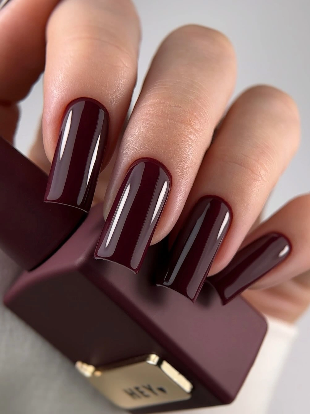 Long square nails in glossy oxblood burgundy