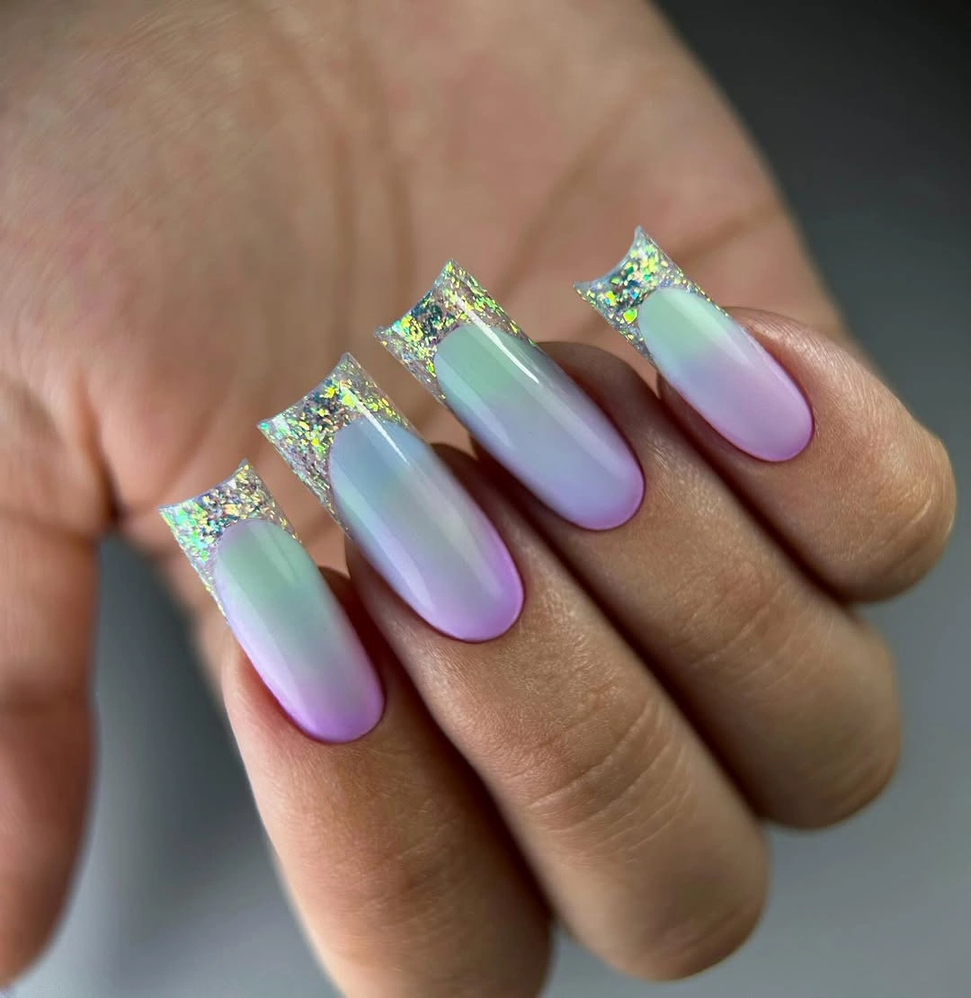 Long square nails with an aqua lilac pink gradient and glitter tips